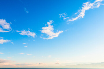 Wall Mural - blue sky with small white clouds over sea coast on a daytime