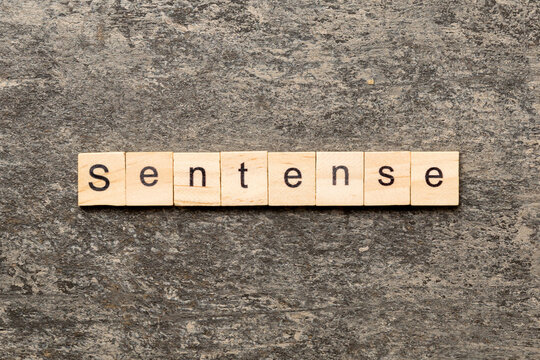 Sentence word written on wood block. Sentence text on table, concept