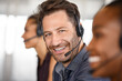 © Rido - Portrait of happy mature customer service man on call