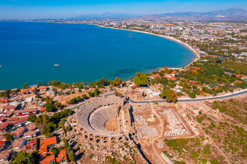 Wall Mural - Antique amphitheater of ancient Side city Antalya Turkey drone photo, aerial top view