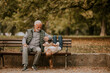 © BGStock72 - Grandfather spending time with his granddaughter on bench in park on autumn day