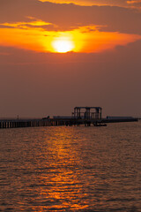 Wall Mural - the sun is shining in the evening moody on the orange sky over the sea