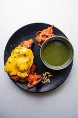 Spicy nawabi tandoori chicken with cheese and chili sauce served in a dish isolated on grey background top view of bangladesh food