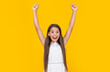 successful teen kid in white dress has long hair on yellow background