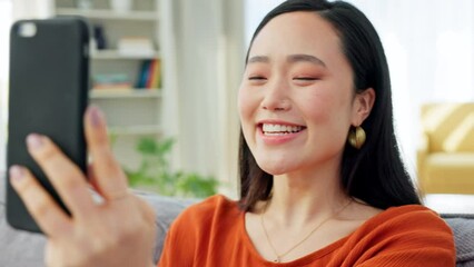 Wall Mural - Communication, phone and Asian woman on video call in home talking, speaking and having conversation. Technology, connection and happy Korean girl on phone call, speaking and chatting online on sofa