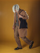© qunica.com - Portrait of a smart young man standing against yellow backgroun