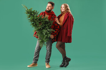 Sticker - Young couple with Christmas tree on green background