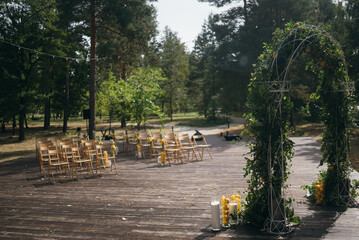 Wall Mural - Wedding arch is decorated with green leaves and lemons.