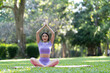 © crizzystudio - Attractive and strong Asian woman with a beautiful body. meditation relax yoga in an elegant posture in the green park Modern concept of relaxation and health care.