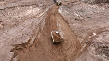 Poster - Mining truck transportation of loosened rock mass. Haulage and transportation of rocks in open-pit mine. Haul truck in sand quarry. Lorry in opencast. Bulk construction supplies in Mining industry.
