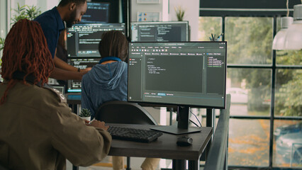 App software developer typing machine learning app code on computer, sitting at desk in big data company office. Cloud programer working on new program interface in cyber security agency.