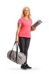 Sticker - Smiling mature woman in sportswear holding a sports bag and an exercise mat