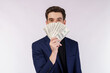 © Johnstocker - Portrait of a cheerful man holding dollar bills over white background