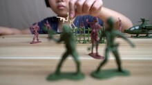Selective Focus The Hand Of Chinese Girl Play Soldier Toy