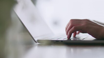 Close-up woman hands typing keyboard on laptop writing programming network.