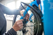 Cropped image of mechanic repairing cargo bike at workshop