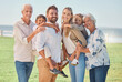 © Beaunitta V W/peopleimages.com - Love, family or portrait in park with grandparents and children for summer, outdoor holiday or wellness. Happy big family, senior man and woman with mom, dad and kids in nature in summer on vacation