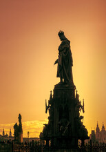 Silhouette Of Charles IV Statue In Prague On Sunset Time. Monument Of Czech King Karel IV Near The Charles Bridge In Praga, Medieval History And Landmarks Of Europe.
