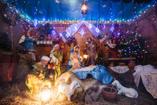 Christmas Crib At A Cologne Christmas Market. The Scene Where The Virgin Mary Gave Birth To Jesus And He Lies In The Cradle Surrounded By People Who Have Come To Celebrate The Nativity Of Christ