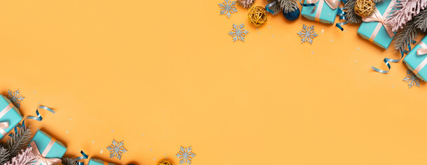 Wall Mural - christmas banner background with pine tree, gifts and festive decorations top view. christmas flat l