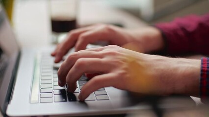 Wall Mural - close up of freelancer's developer hands typing program code on laptop keyboard in coworking. busine