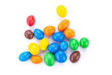 Colorful chocolate buttons, on white background.