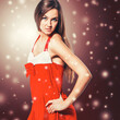 © yurolaitsalbert - young woman in Santa Claus costume posing in front of the camera.