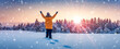 © candy1812 - A woman stands on a snowy field with her hands raised up.
