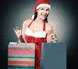 © yurolaitsalbert - happy young woman dressed as Santa Claus with the Christmas shop