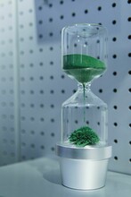 Vertical Shot Of A Magnetic Green Sand Hourglass