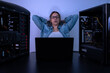 © Pajaros Volando - Empowered woman working in programming with her computers in dark background