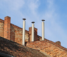 Smoke Stacks On The Roof Of A House