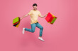 © deagreez - Full length photo of positive overjoyed man wear trendy clothes moving empty space carry packs isolated on pink color background