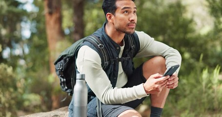 Nature hiking man, typing phone and sitting on rock for rest, break or relax with backpack outdoor. Forest adventure, woods explorer and smartphone for coordinate direction on gps navigation by trees