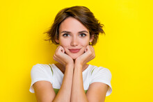 Photo Of Pretty Cute Nice Glad Girl With Bob Hairstyle Dressed White T-shirt Arms On Cheekbones Isolated On Yellow Color Background