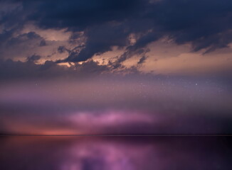 Wall Mural -   night  starry sky  and moon at sea lilac blue nebula cosmic milky way Aurora   seascape