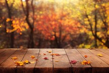 A Wooden Table Topped With Lots Of Autumn Leaves, A Wood Surface With Fall Leaves On It.