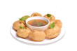 Delicious north and south indian street food pani puri gol gappa with tamarind water served in white plate and potato and chickpeas for food photography