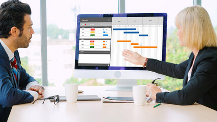 Project planning software for modish business project management on the computer screen showing timeline chart of the team project