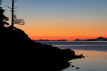 Poster - Silhouette of a hill by the lake on the sunset