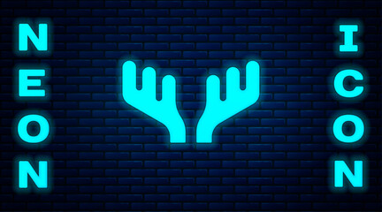 Sticker - Glowing neon Deer antlers icon isolated on brick wall background. Hunting trophy on wall. Vector