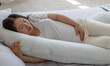 Pregnant woman with pregnancy pillow