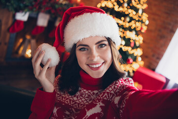 Poster - Portrait of pretty positive lady hand touch headwear pom pom make selfie toothy smile house indoors