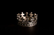 crown shaped ring made of solid sterling silver with cross on it. jewelry for brutal men on black background 