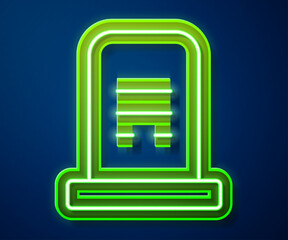 Sticker - Glowing neon line Grave with tombstone icon isolated on blue background. Vector