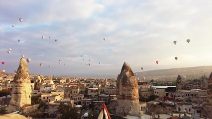 Wall Mural - Panoramic view of Goreme, Turkey with hot-air balloons. Goreme is known for its fairy chimneys, eroded rock formations