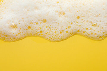 Sticker - Fluffy soap foam on yellow background, top view. Space for text