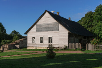 View of a traditional Russian wooden house on the territory of the Izborsk fortress on a sunny summer day, Izborsk, Pechersk district, Pskov region, Russia