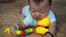 Asian Baby Chew The Worm Toy. Concept Of New Generation, Parenthood, Family