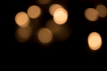 Golden bokeh light isolated on black background